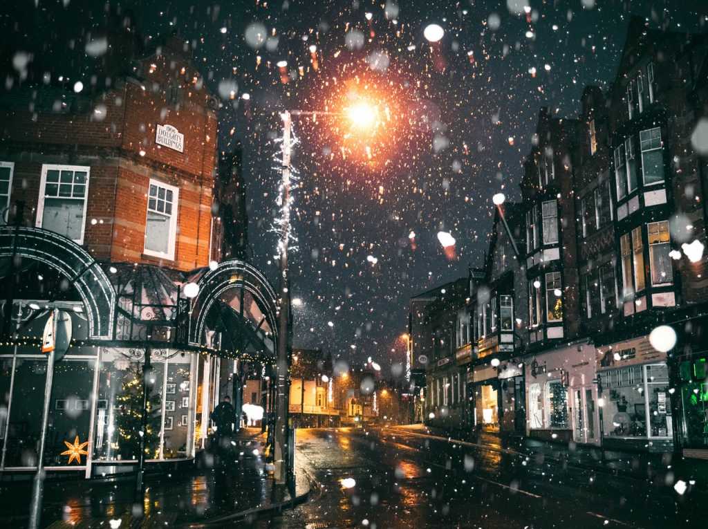 Town streets at nioght during the winter with snow falling Mobile Tyres 2 U